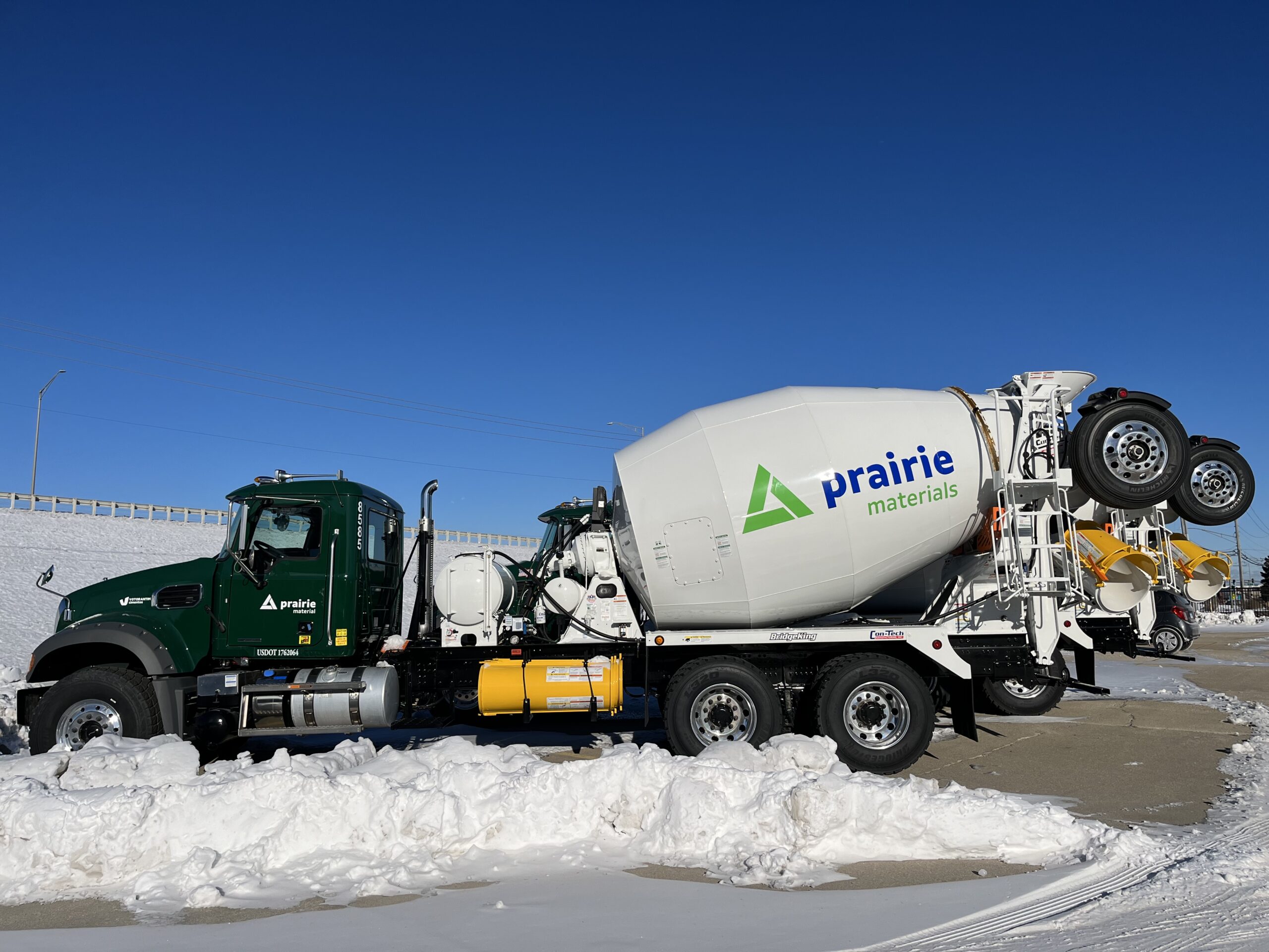 IDOT Approved Concrete Supplier - green Prairie Materials mixer truck in a snowy plant yard